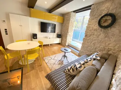 a living room with a couch and a table at COCON AP4446 By Riviera Holiday Homes in Villefranche-sur-Mer
