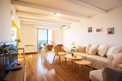 a living room with a couch and a table at LE JARDIN BLEU AP4388 By Riviera Holiday Homes in Nice