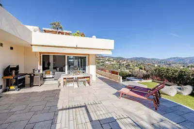 a patio of a house with a table and chairs at Bay of Angels by ecoflats in Nice
