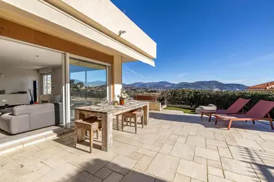 a patio with a table and chairs and a couch at Bay of Angels by ecoflats in Nice