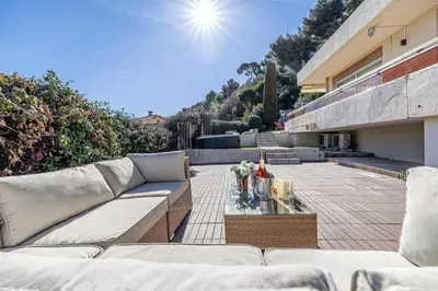 a patio with a couch and a table on a building at Bay of Angels by ecoflats in Nice