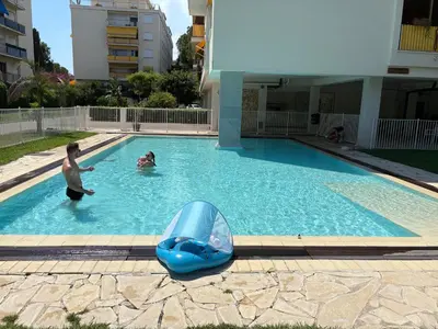 a group of people playing in a swimming pool at NICE La Palmeraie Pool BEACH AC in Nice