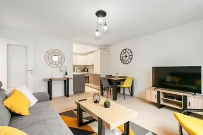 a living room with a couch and a table at Suite Matisse FSHH - Generale in Nice