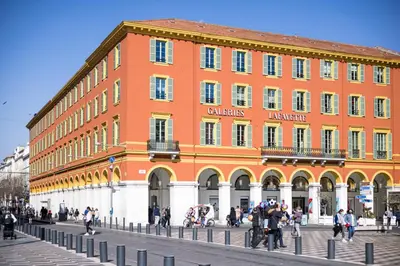 a large orange building with people walking in front of it at FEEL HOME - Poissonnerie in Nice