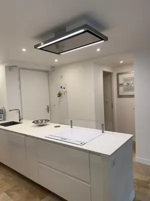 a kitchen with a white counter and a sink at Maison avec jacuzzi privatif dans résidence in La Gaude
