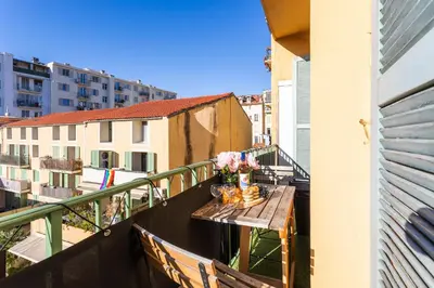 a balcony with a table with flowers on it at Garibaldi AP4447 By Riviera Holiday Homes in Nice