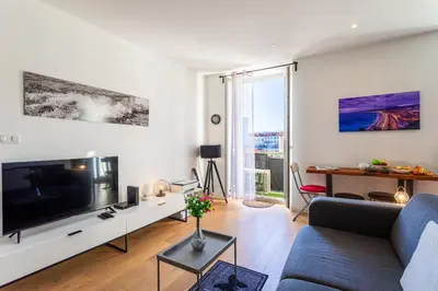 a living room with a large flat screen tv at Garibaldi AP4447 By Riviera Holiday Homes in Nice