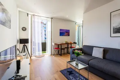 a living room with a couch and a table at Garibaldi AP4447 By Riviera Holiday Homes in Nice