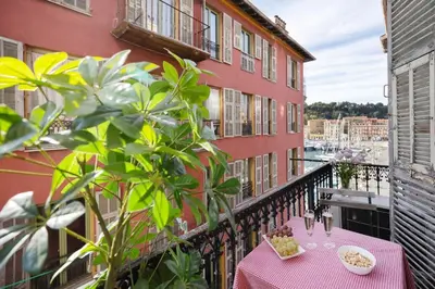 a table on the balcony of a building at Seabreeze Apt Nice Port in Nice