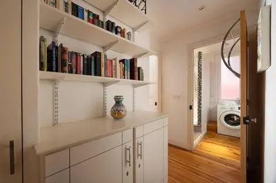 a kitchen with white cabinets and bookshelves at Seabreeze Apt Nice Port in Nice