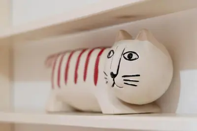 a white cat vase sitting on a shelf at Seabreeze Apt Nice Port in Nice