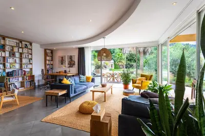 a living room with a blue couch and chairs at VILLA NIDAZUR VI4413 By Riviera Holiday Homes in Nice