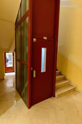 a red door in a room with a staircase at Hyper Centre, balcon, 5min de la plage, AC in Nice