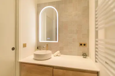 a bathroom with a sink and a mirror at Hyper Centre, balcon, 5min de la plage, AC in Nice