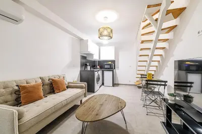 a living room with a couch and a table at 1 Bdr Duplex Downtown - AC in Nice