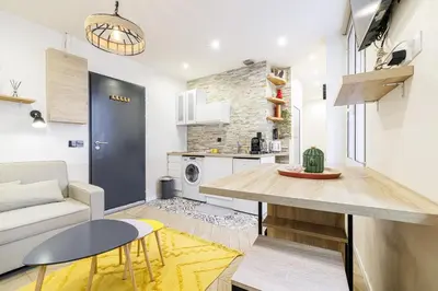 a kitchen and living room with a table and a couch at Ultra Central 1 Bdr - AC in Nice