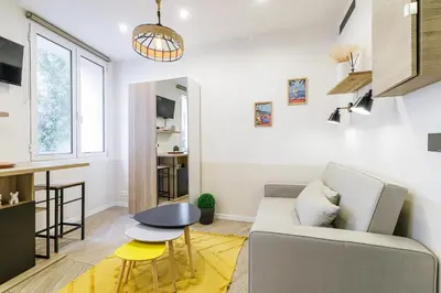 a living room with a couch and a table at Ultra Central 1 Bdr - AC in Nice