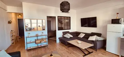 a living room with a couch and a table at Votre COCON Niçois Appart Vue Mer in Nice