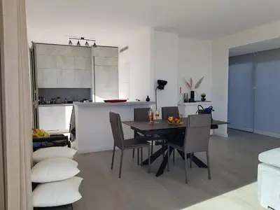 a kitchen and dining room with a table and chairs at Laconsolate in Nice
