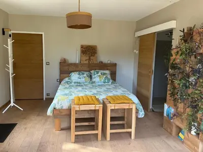 a garden with a table and chairs in front of a mountain at Chambres d hôtes les Romarins in Cantaron