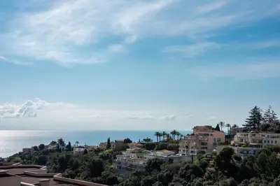 a view of a city with the ocean and buildings at Happyfew la terrasse de Selfina in Nice