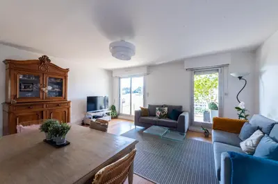 a living room with a table and a couch at Happyfew la terrasse de Selfina in Nice