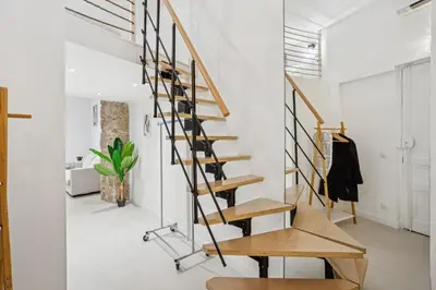 a spiral staircase in a room with white walls at La Promenade Niçoise in Nice