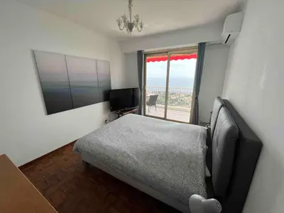 a bedroom with a bed and a television and a window at Beautiful Apartment Pool & Garage See View in Nice