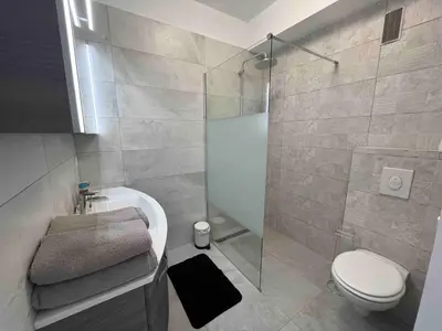 a bathroom with a shower and a toilet and a sink at Beautiful Apartment Pool & Garage See View in Nice