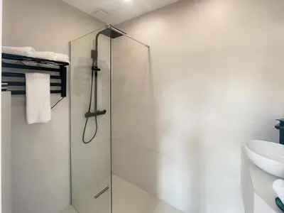 a bathroom with a glass shower and a sink at Nice Gare Studio in Nice