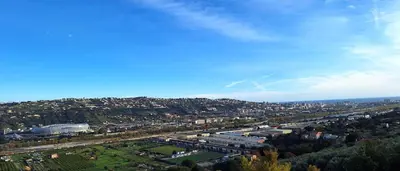 an aerial view of a city with buildings and trees at Chambres d'hôtes D'AQUI D'AIA in Saint-Laurent-du-Var