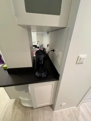 a small kitchen with a coffee maker in a counter at MUSICIENS Joli DUPLEX 2 Chambres Garage privatif et Terrasse in Nice