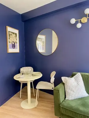 a living room with a table and a green couch at Cosy 1 Bedroom Place Massena in Nice