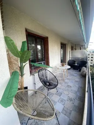 a balcony with two chairs and a table on a building at Nice Ouest Caucade- Beautiful 2P, AC, Clim in Nice