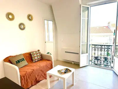 a living room with a couch and a table at Beautiful & cosy appart, calme et lumineux in Nice