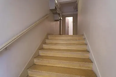 a staircase in a building with stairs leading to a door at Nice Renting - HONORE - Elegant apartment near Promenade des Anglais in Nice