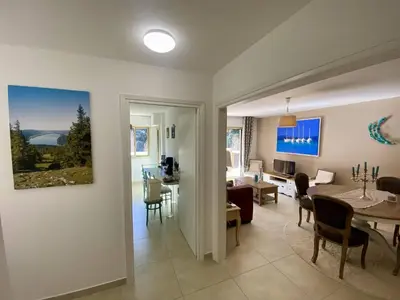 a living room with a table and a dining room at Nice Ouest 2P Sea view, Pool, Quiet in Nice