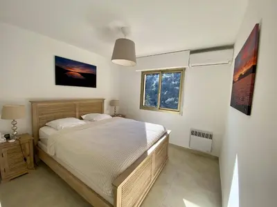 a bedroom with a bed and a window at Nice Ouest 2P Sea view, Pool, Quiet in Nice