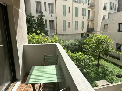 a green bench sitting on the balcony of a building at Rivoli- Quiet apartment, close to Negresco in Nice