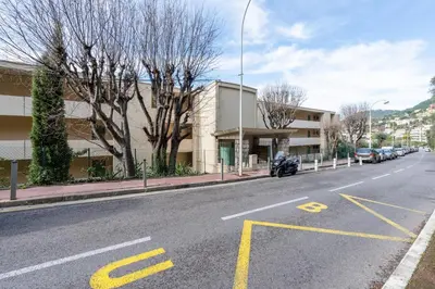 an empty street with cars parked on the side of a building at Cozy Appartement close to Port of Nice in Nice