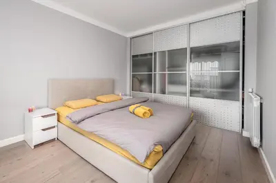 a bedroom with a large bed with yellow pillows on it at Cozy Appartement close to Port of Nice in Nice