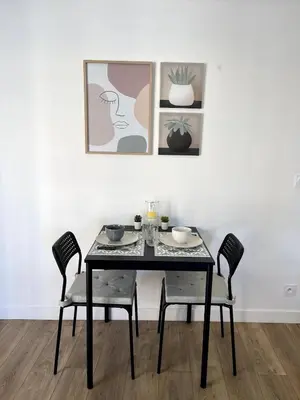 a black dining room table with two chairs at Joli Studio Place Garibaldi, Vieux-Nice, Port in Nice