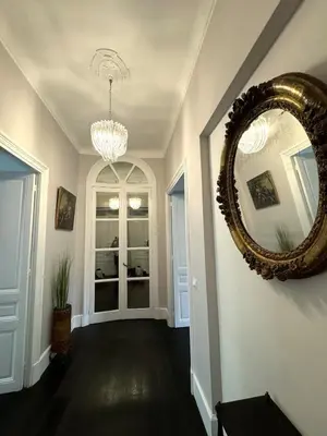 a hallway with a large mirror on the wall at Carré d'Or, superbe apartment sur jardin, élégant et ensoleillé in Nice