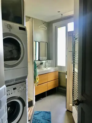 a bathroom with a washing machine and a sink at Beau 3 pièces Libération Nice in Nice