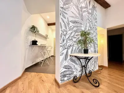 a room with a table with a plant on a wall at ApartHotel Riviera - La Maison De Francois - Old Town in Nice