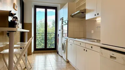 a kitchen with a washer and dryer and a balcony at ApartHotel Riviera - Terrasse Felix Faure 2 - Massena in Nice
