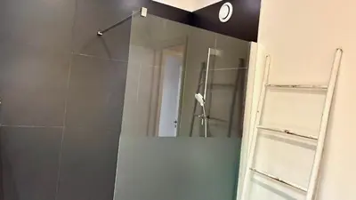 a bathroom with a shower with a mirror at ApartHotel Riviera - Terrasse Felix Faure 2 - Massena in Nice