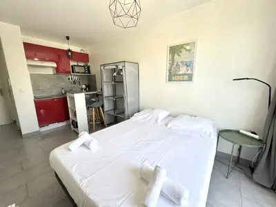 a bedroom with a white bed with two white towels at ApartHotel riviera - Balcon Jean Jaures 2 - Place Massena - Old in Nice