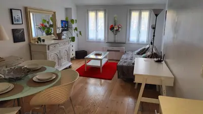 a living room with a table and a bed at Beach Proximity in Historic Nice, Your Perfect 2 Room Rental in Nice