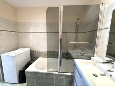 a bathroom with a shower and a sink and a tub at ApartHotel Riviera - Hotel des Postes 2 - City center Massena in Nice